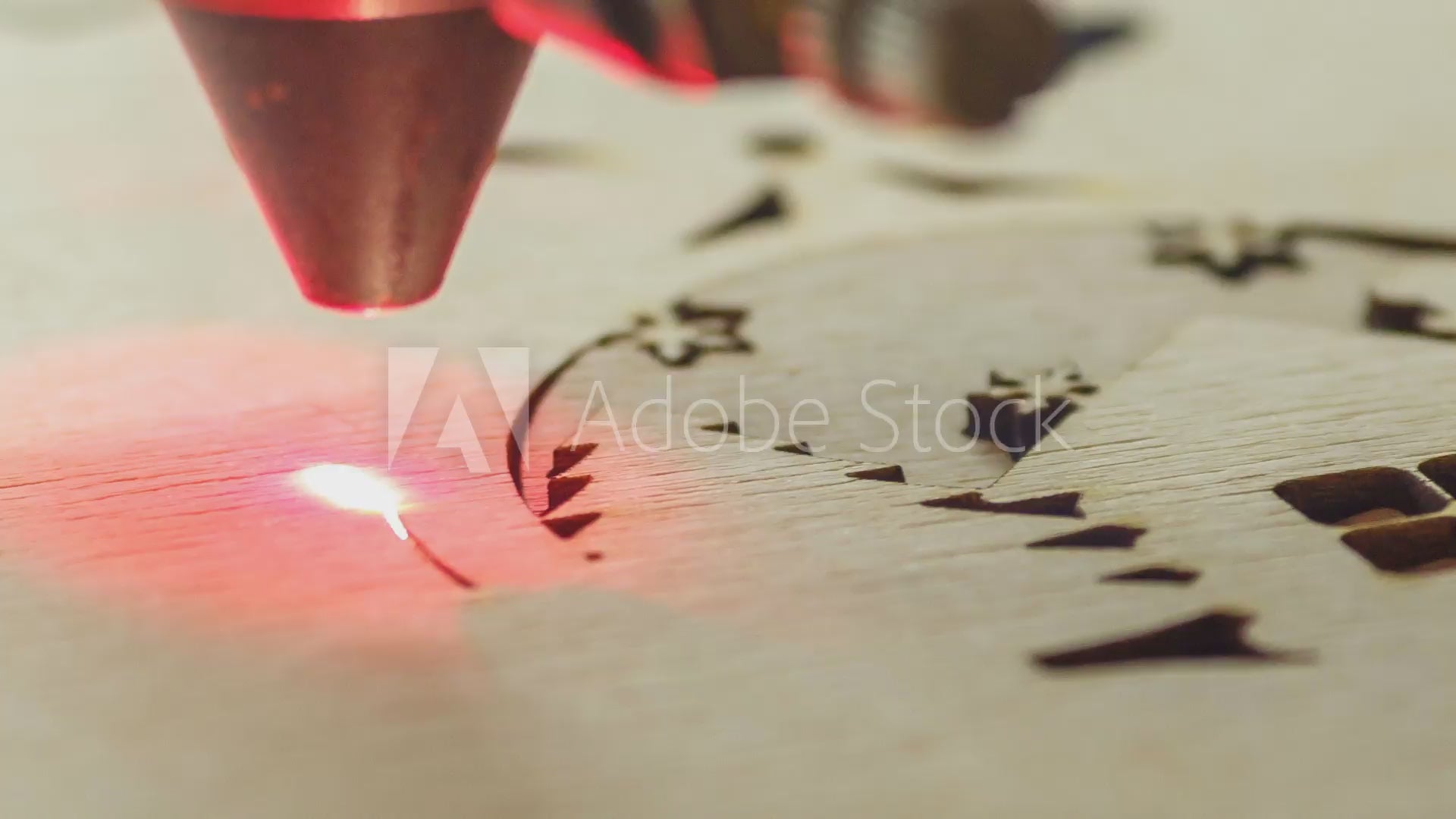 Load video: shows laser cutting out intricate design in wood